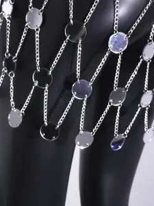 Close-up detail of sexy silver body chain skirt with reflective acrylic mirror discs