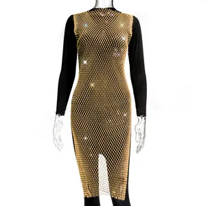 Detail view of a gold fishnet mesh dress with sparkling rhinestones over a black base.