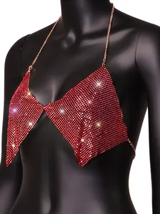 Detailed macro view of sparkling red rhinestone mesh and gold chain on a halter top