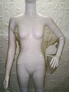 Detailed view of long-sleeve gold mesh dress with sparkling rhinestone embellishments