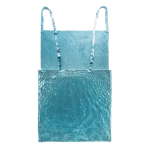 Close-up detail showing the shimmering blue metallic sequined fabric of a slip dress