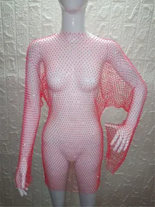 Macro view showing the intricate pink mesh pattern and glittering rhinestone details on a dress.
