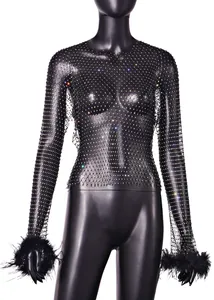 Close-up of black fishnet long sleeve top with iridescent rhinestones and fur cuffs.