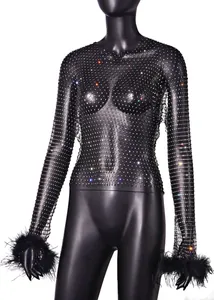 Sparkling rhinestone mesh long sleeve top with black feather cuffs on a mannequin