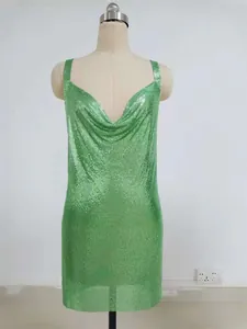 Detailed shot of a shimmering lime green sequined sling mini dress displayed on a mannequin