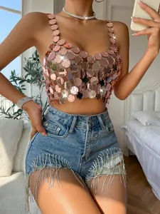 Detail view of pink acrylic disc sequin halter top and rhinestone fringe denim shorts.