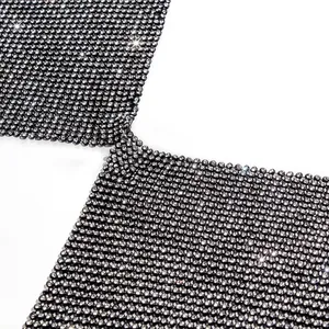 Macro detail view of black rhinestone mesh fabric with sparkling crystals for party top