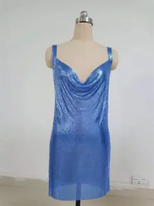 Close-up of the shimmering blue sequined metallic mesh fabric on a stylish party dress.