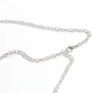 Close-up detail of silver chain links and lobster clasp for women's backless top