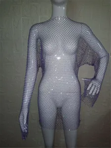 Detail view of the purple sheer mesh long sleeve mini dress featuring sparkling rhinestones.