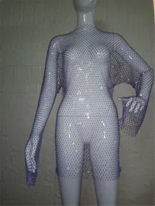 Detailed view of glamorous purple rhinestone fishnet mesh mini dress on white mannequin