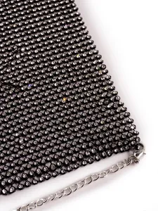 Macro view of sparkly rhinestone mesh fabric with silver chain strap and lobster clasp