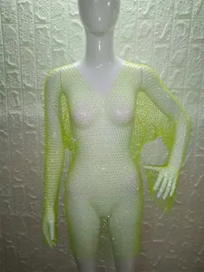 Detail of neon yellow long sleeve mesh dress with sparkling rhinestone accents.