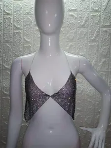 Close-up of a sparkling rhinestone halter top with delicate chain straps for parties.