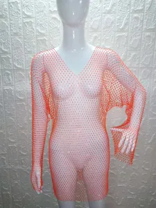 Close-up detail of orange rhinestone mesh long-sleeve dress on mannequin