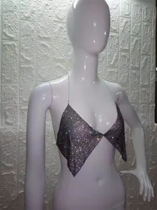 Close-up view of a sparkling rhinestone halter top displayed on a white mannequin