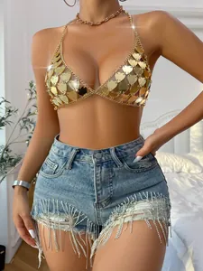 Close-up detail of golden acrylic heart-shaped sequins on a backless chain link festival top