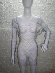 Close-up of elegant rhinestone mesh long sleeve mini dress on mannequin for party wear.
