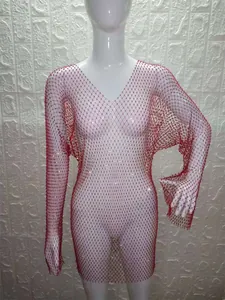 Detail view of a red long sleeve mesh dress decorated with sparkling rhinestones.