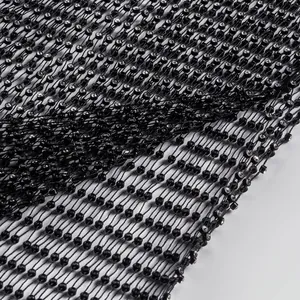 Macro view showing the intricate black mesh and glittering rhinestone detail of the dress