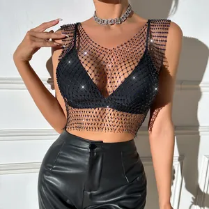 Close-up of a sparkling black rhinestone fishnet mesh crop top worn over a bikini top