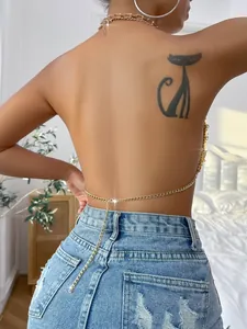 Detailed view of a sexy backless gold chain vest with acrylic heart accents for summer.