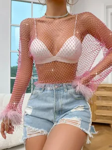 Close-up of pink rhinestone mesh top featuring feathered cuffs and diamond details.