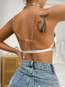 Detailed back view of a white cropped top featuring pink crystal chains and gold accents