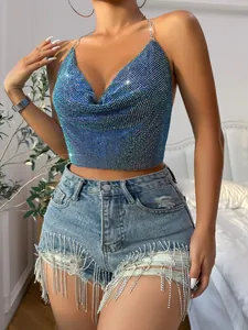 Glittering blue sequin halter top with cowl neck and rhinestone fringe denim shorts