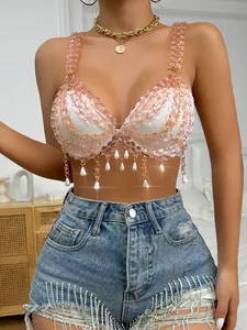 Detail view of pink crystal beaded chain crop top with faux pearl tassels and gold hardware