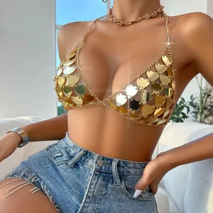 Detail view of a golden acrylic heart sequin chain bra for sexy festival summer outfits.