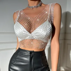 Close-up of sparkly rhinestone mesh tank top with elegant white satin bralette detail