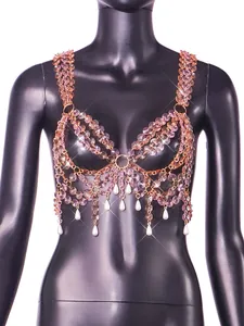 Detailed view of shimmering pink faceted beads and white pearl tassels on a body chain bra top