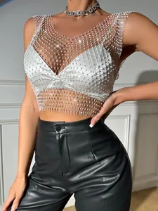 Close-up of sexy white fishnet tank top with shimmering rhinestones for party wear.
