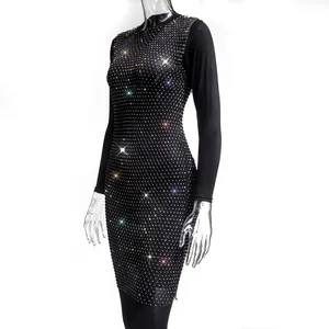 Detailed view of elegant black long-sleeve dress with a sparkling rhinestone grid pattern