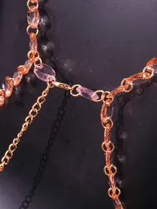 Close-up macro detail of elegant pink and orange faceted gemstone chain strap for tops