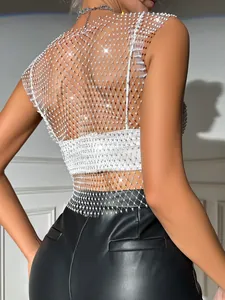 Detail of white rhinestone fishnet top featuring sparkling crystal accents and mesh design