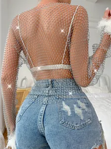 Close-up of sparkling fishnet mesh long sleeve top with rhinestone details