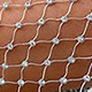 Close-up detail of the sparkly rhinestone mesh fabric on a stylish hollow fishnet T-shirt top