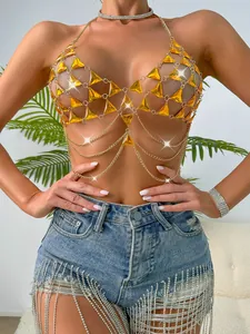 Detail of a sexy gold body chain vest featuring orange triangle gems for summer