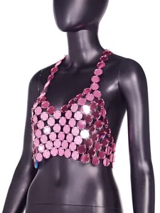Close-up detail shot of pink sequined acrylic halter crop top with shiny disc elements.