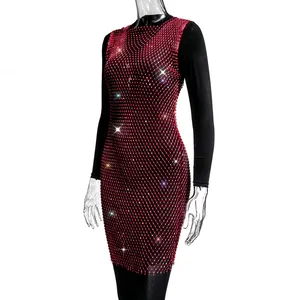 Detailed view of a red mesh sparkling rhinestone dress on a mannequin for parties.