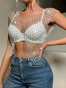 Detailed view of the sparkling rhinestone fishnet crop top with a split hem design