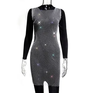 Close-up of elegant black long-sleeve dress with silver rhinestone mesh overlay