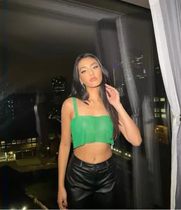 Stylish green sequin metallic mesh crop top camisole showing a trendy evening party look