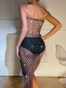Macro detail of sexy silver rhinestone mesh dress with sparkling fringe tassels