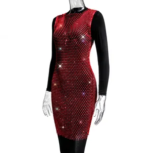 Close-up of red mesh dress with sparkling rhinestone details for a glamorous look.