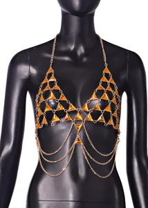Sexy gold-tone metal body chain bra featuring orange triangle gemstones on a black mannequin