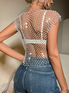 Close-up detail of sexy white fishnet crop top decorated with shimmering rhinestones