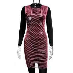 Close-up of elegant pink rhinestone mesh dress with shimmering crystals on white